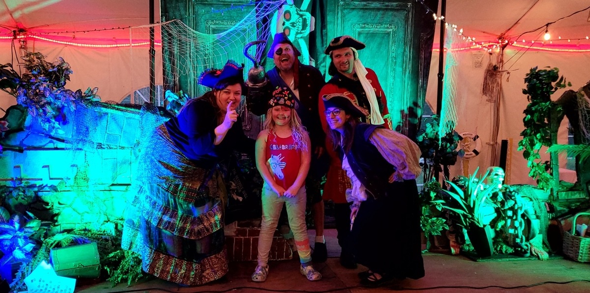 Audience solving clues at a swashbuckling pirate-themed murder mystery in Bayville NJ