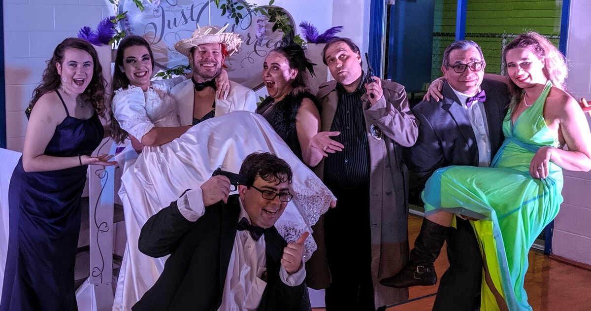 Audience enjoying an interactive 80’s-themed murder mystery performance in Brandywine DE
