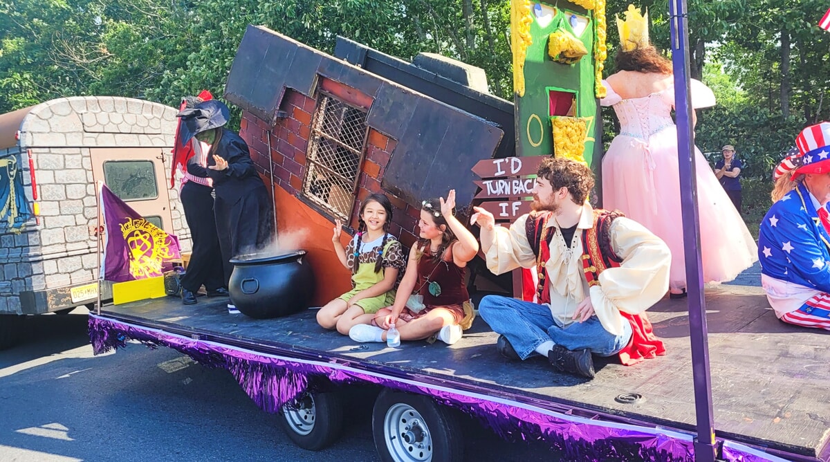 The Castle Bus with costumed actors performing at the Smithville Fourth of July Parade