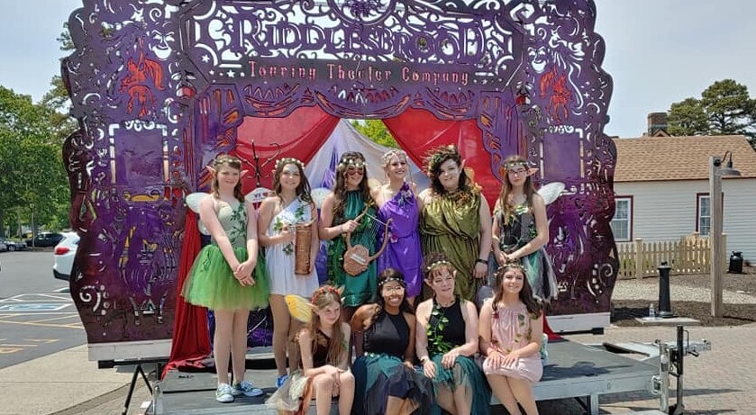 Cast members adorned in elaborate fantasy-themed costumes during the 'Harken' mainstage performance.