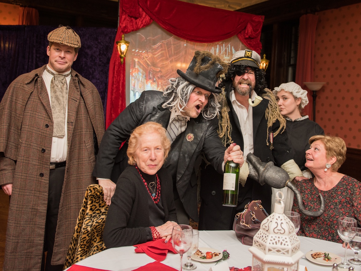 Audience captivated by a dramatic Sherlock Holmes murder mystery scene on stage