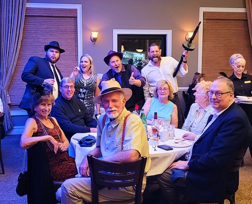 Audience engaged in solving a thrilling 1920s gangster murder mystery