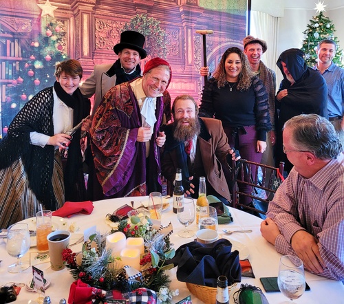 Actors delight the audience with a live retelling of 'A Christmas Carol' at a holiday dinner